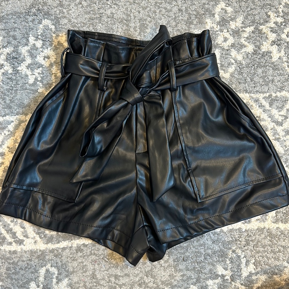 SHEIN black leather shorts with bow tie in the front and has pockets